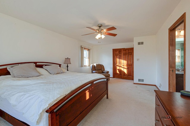 bedroom with light colored carpet, ceiling fan, visible vents, and baseboards