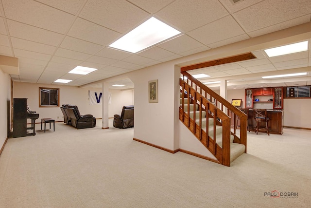 finished below grade area featuring stairway, carpet, and baseboards