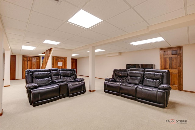 cinema featuring a paneled ceiling, carpet flooring, and baseboards