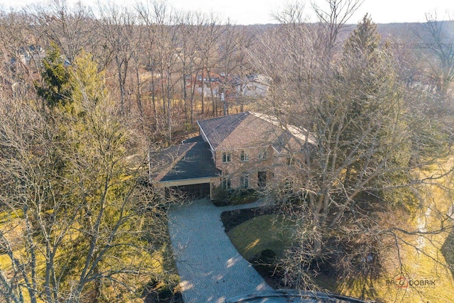 birds eye view of property featuring a view of trees