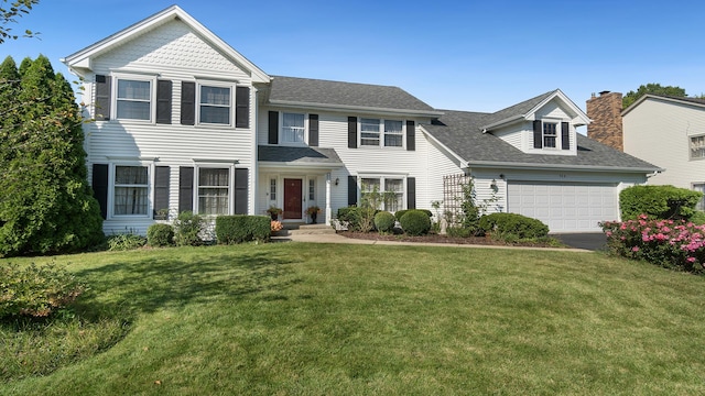 view of front of property with a shingled roof, a front yard, driveway, and an attached garage