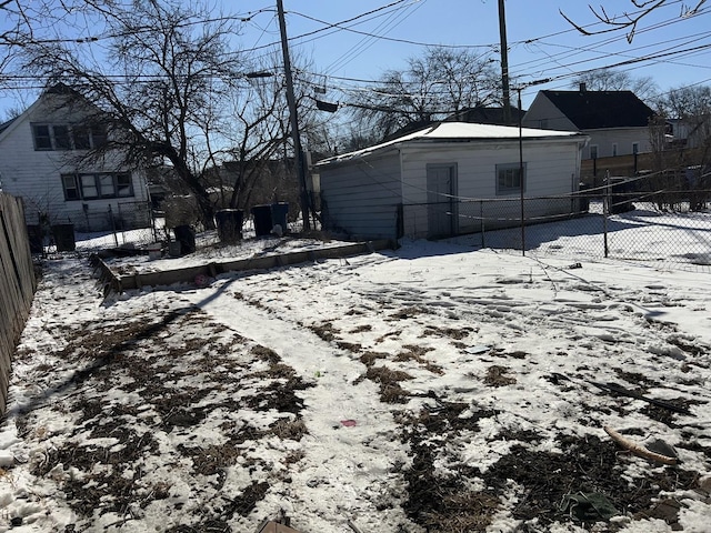 snowy yard with a fenced backyard