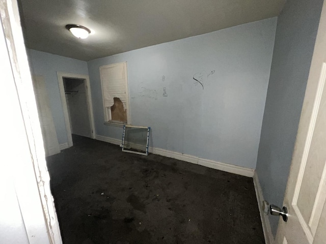 unfurnished room featuring baseboards