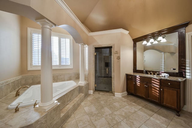 bathroom with a shower stall, vaulted ceiling, vanity, and ornate columns