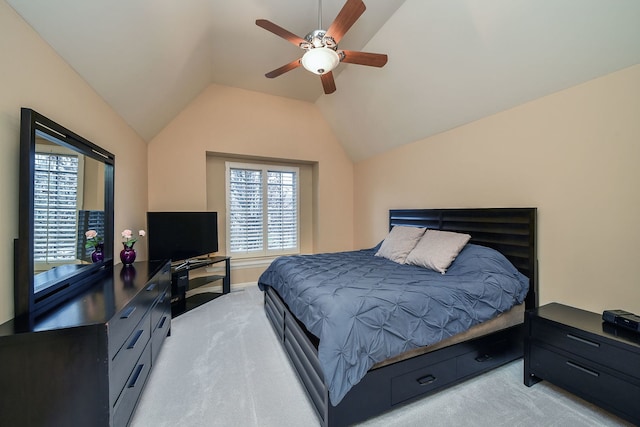 bedroom featuring lofted ceiling, a ceiling fan, and light colored carpet