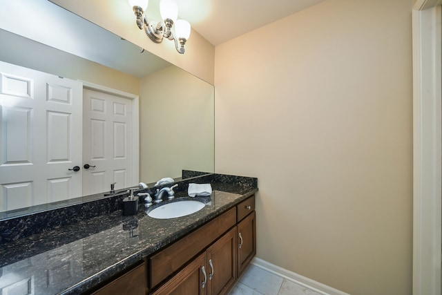 bathroom featuring vanity, baseboards, and tile patterned floors