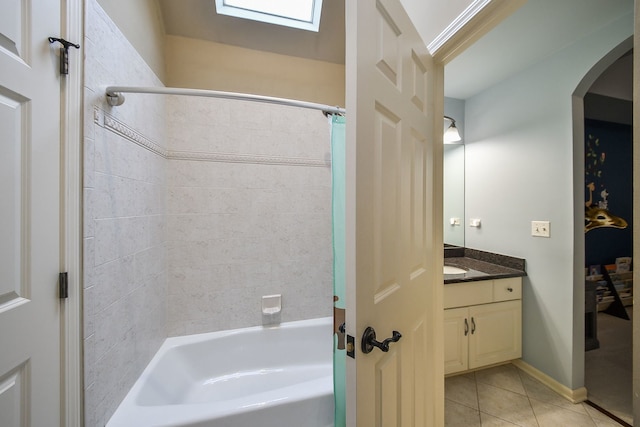 bathroom with tile patterned flooring, shower / bathtub combination with curtain, baseboards, and vanity