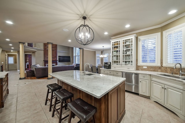 kitchen with dishwasher, light tile patterned floors, and a sink