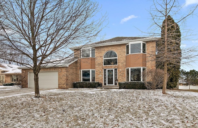 view of front of property featuring concrete driveway, brick siding, and an attached garage