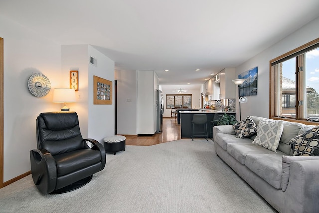 living room featuring recessed lighting, carpet, visible vents, and baseboards