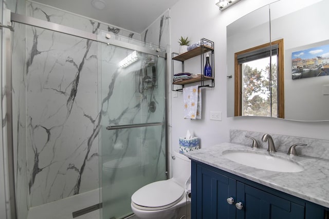 bathroom with vanity, a marble finish shower, and toilet