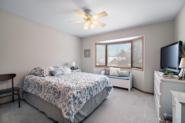 bedroom with light carpet, ceiling fan, and baseboards