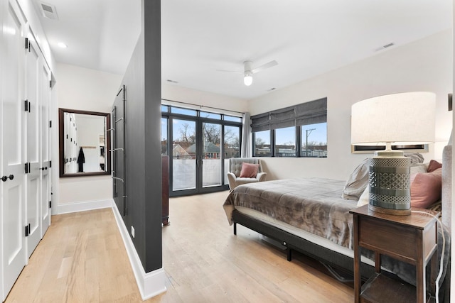 bedroom featuring baseboards, visible vents, access to outside, french doors, and light wood-style floors