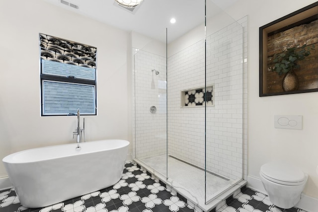 bathroom with toilet, tiled shower, a soaking tub, and visible vents