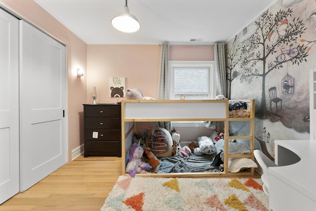 bedroom featuring visible vents and wood finished floors