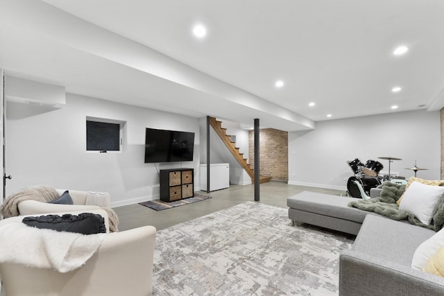 living area with finished concrete floors, recessed lighting, baseboards, and stairs