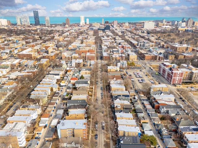 birds eye view of property featuring a water view and a city view