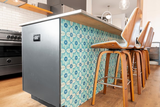 kitchen with extractor fan, wood finished floors, and stainless steel electric stove