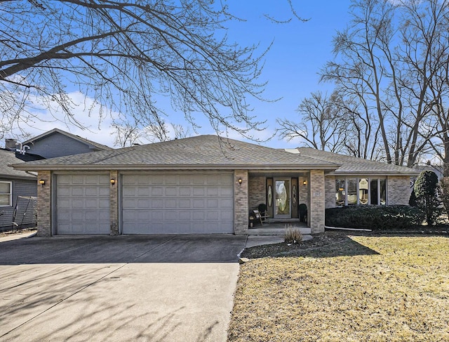 ranch-style home featuring an attached garage, driveway, roof with shingles, and brick siding