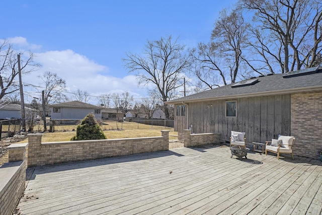 deck featuring fence and a fire pit