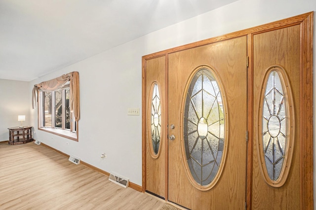 entrance foyer with light wood-style flooring, visible vents, and baseboards