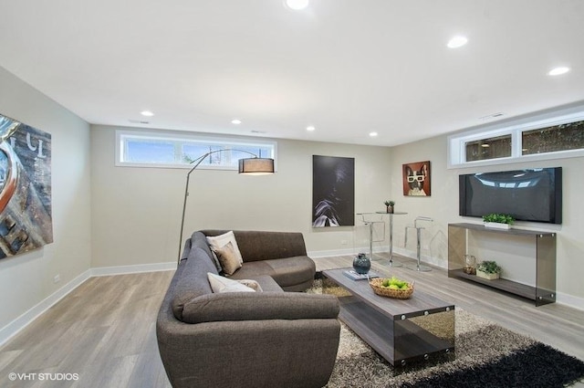 living area with recessed lighting, baseboards, and wood finished floors