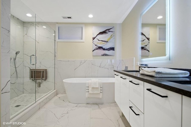 bathroom featuring marble finish floor, visible vents, a freestanding bath, and a marble finish shower