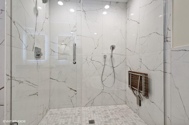 full bathroom with heating unit and a marble finish shower