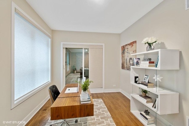 office featuring wood finished floors, visible vents, and baseboards