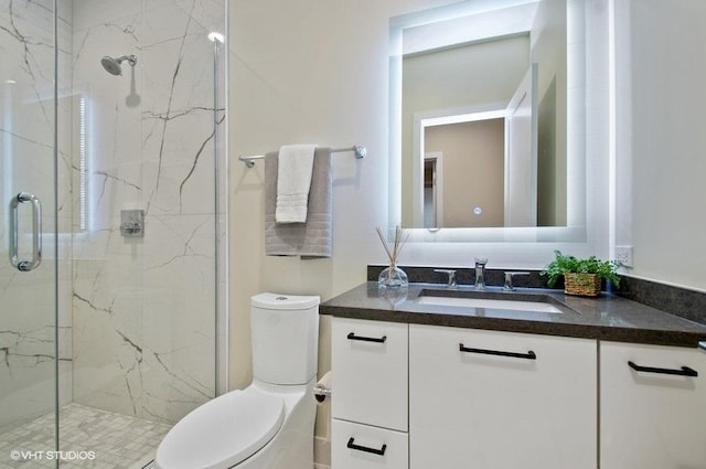 full bathroom with toilet, vanity, and a marble finish shower