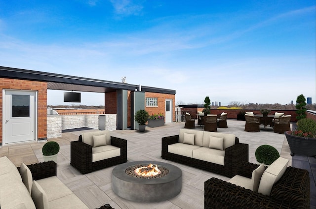 view of patio / terrace featuring outdoor dining area and an outdoor living space with a fire pit