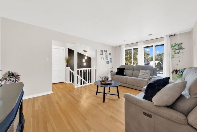 living room featuring light wood-type flooring and baseboards