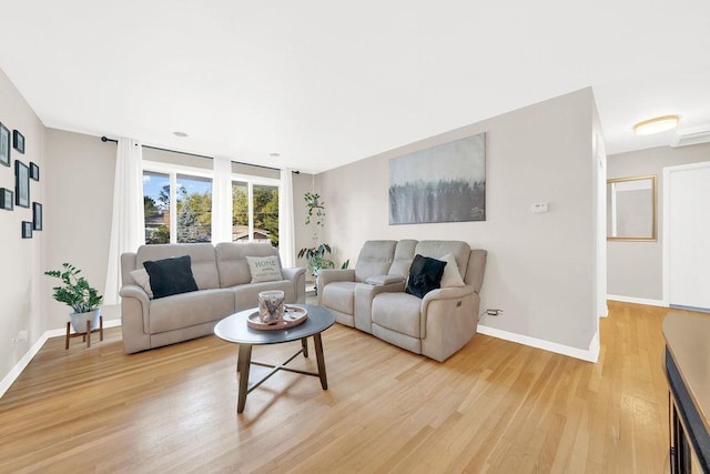 living room featuring light wood-style flooring and baseboards