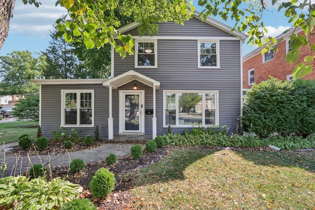 traditional-style home with a front lawn