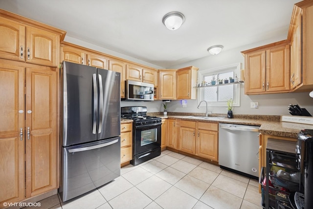 kitchen with a sink, stainless steel appliances, light tile patterned flooring, and light brown cabinetry