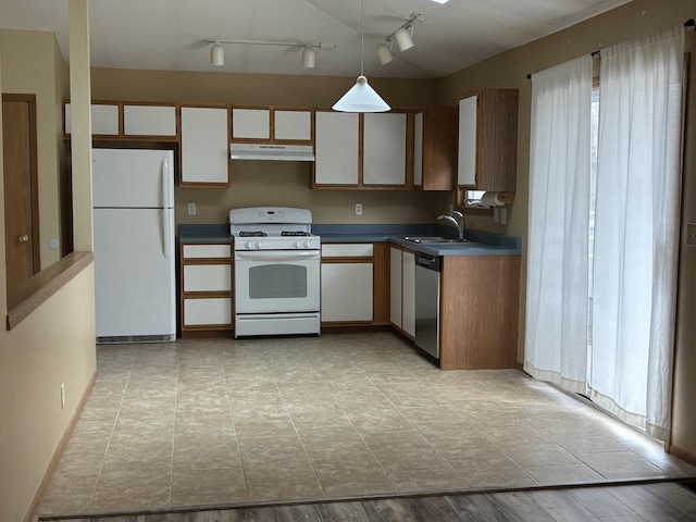 kitchen with pendant lighting, white cabinets, a sink, white appliances, and under cabinet range hood