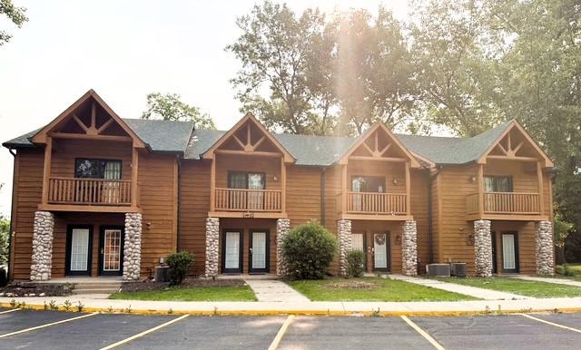2643 N Il Route 178th Hwy Unit 2-2, Utica, IL 61373 - view of front of property featuring a balcony, uncovered parking, stone siding, and french doors