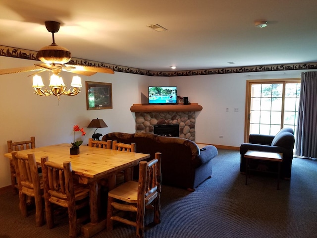 carpeted dining space featuring visible vents, a fireplace, baseboards, and an inviting chandelier