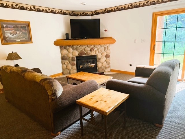 2643 N Il Route 178th Hwy Unit 2-2, Utica, IL 61373 - living area featuring carpet flooring, baseboards, and a stone fireplace