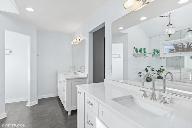 bathroom with tile patterned floors, two vanities, a sink, and recessed lighting