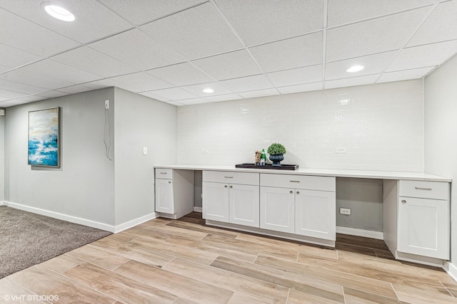 bar with light wood-style floors, recessed lighting, built in study area, and baseboards