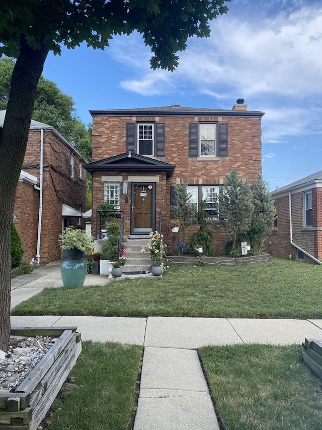 view of front of home featuring brick siding and a front lawn