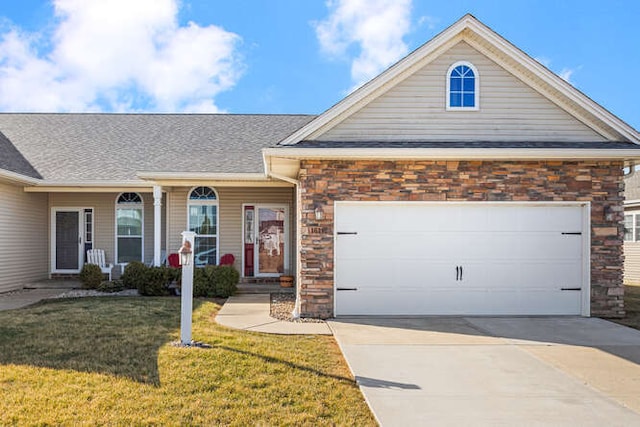 view of front of home featuring a front lawn, stone siding, covered porch, concrete driveway, and a garage