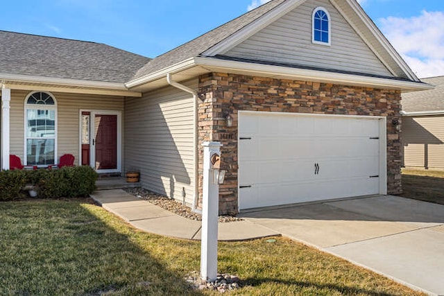 view of front of house with stone siding, concrete driveway, a front yard, a shingled roof, and a garage