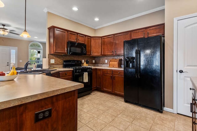 kitchen featuring black appliances, a sink, tasteful backsplash, a peninsula, and hanging light fixtures