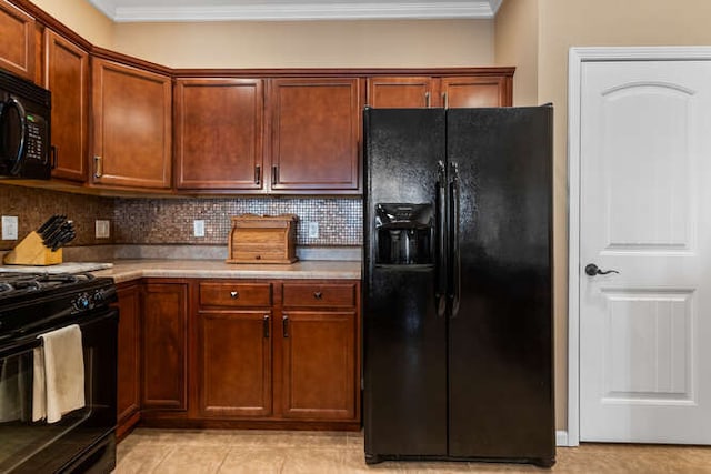 kitchen featuring backsplash, crown molding, light countertops, light tile patterned flooring, and black appliances