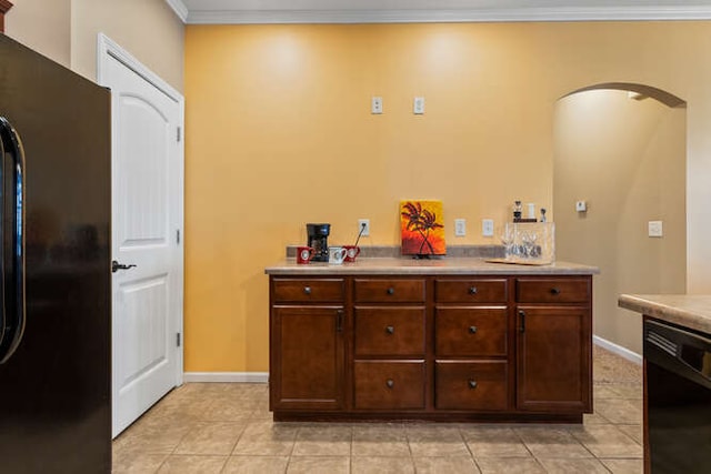 interior space featuring crown molding, baseboards, and tile patterned floors