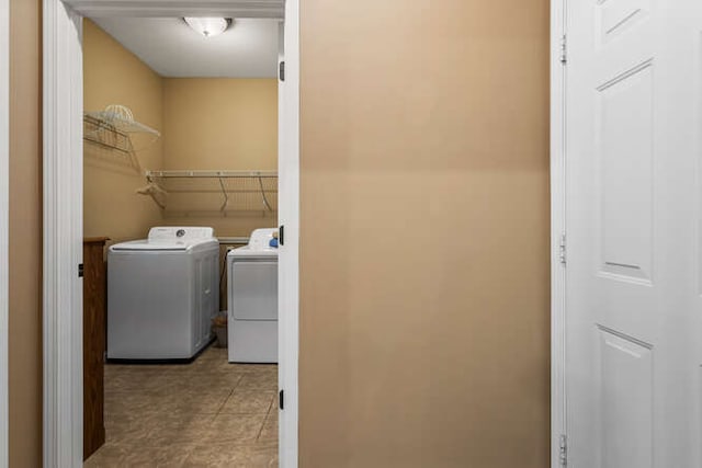 laundry room featuring independent washer and dryer, laundry area, and tile patterned flooring