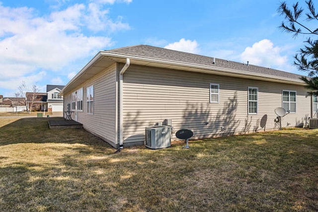 view of home's exterior featuring central AC unit and a lawn