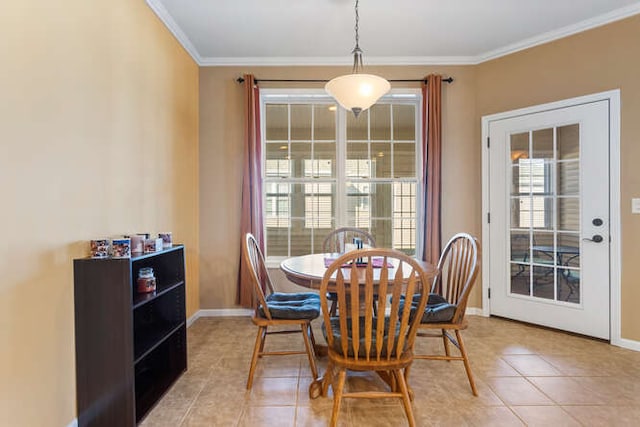 dining area featuring light tile patterned floors, baseboards, and crown molding